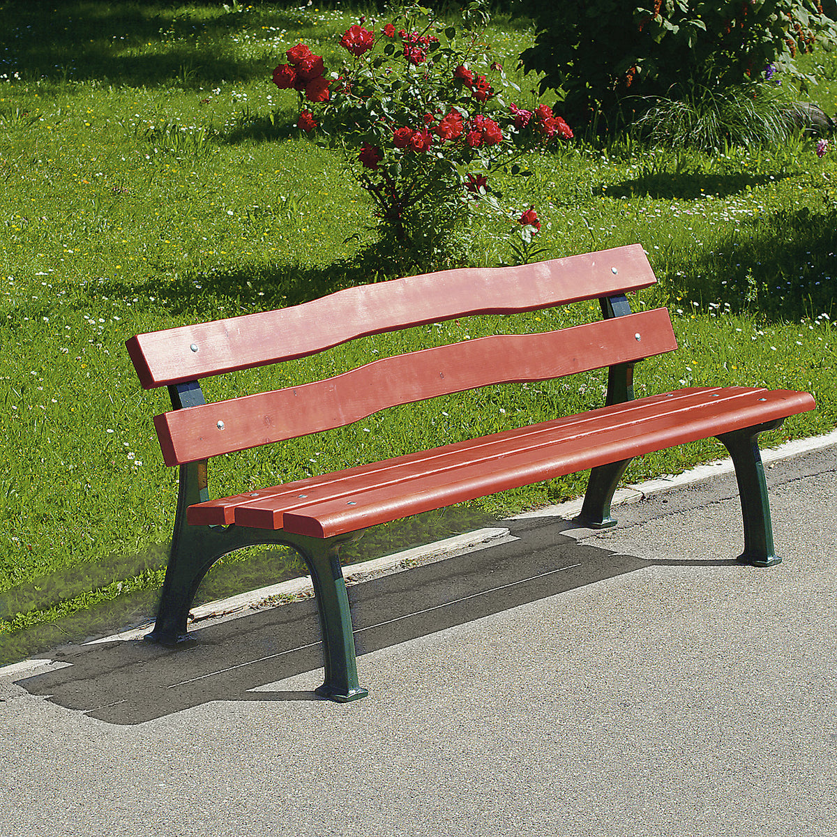 Park bench, solid cast iron frame, seat and back rest made of pine wood, curved.