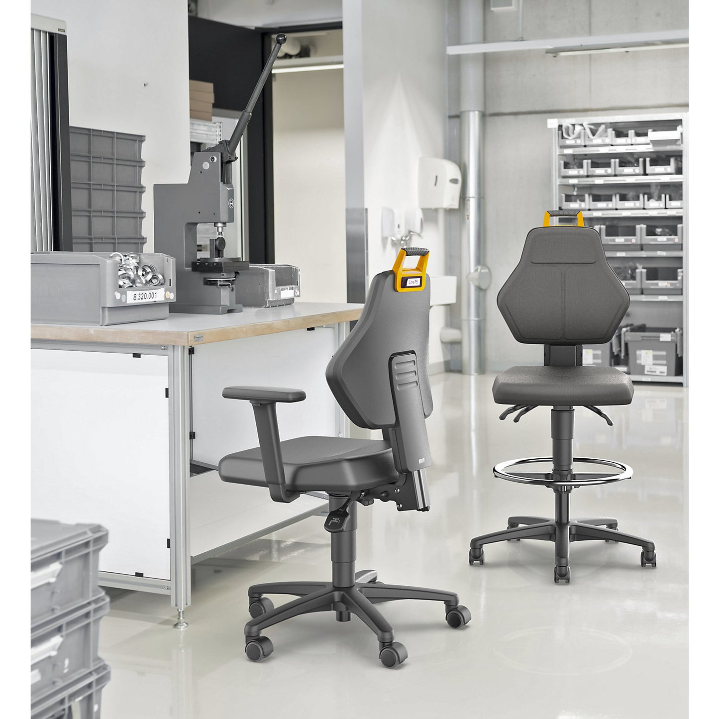 Industrial swivel chair, black, with sit-stop castors and foot ring, fabric cover.
