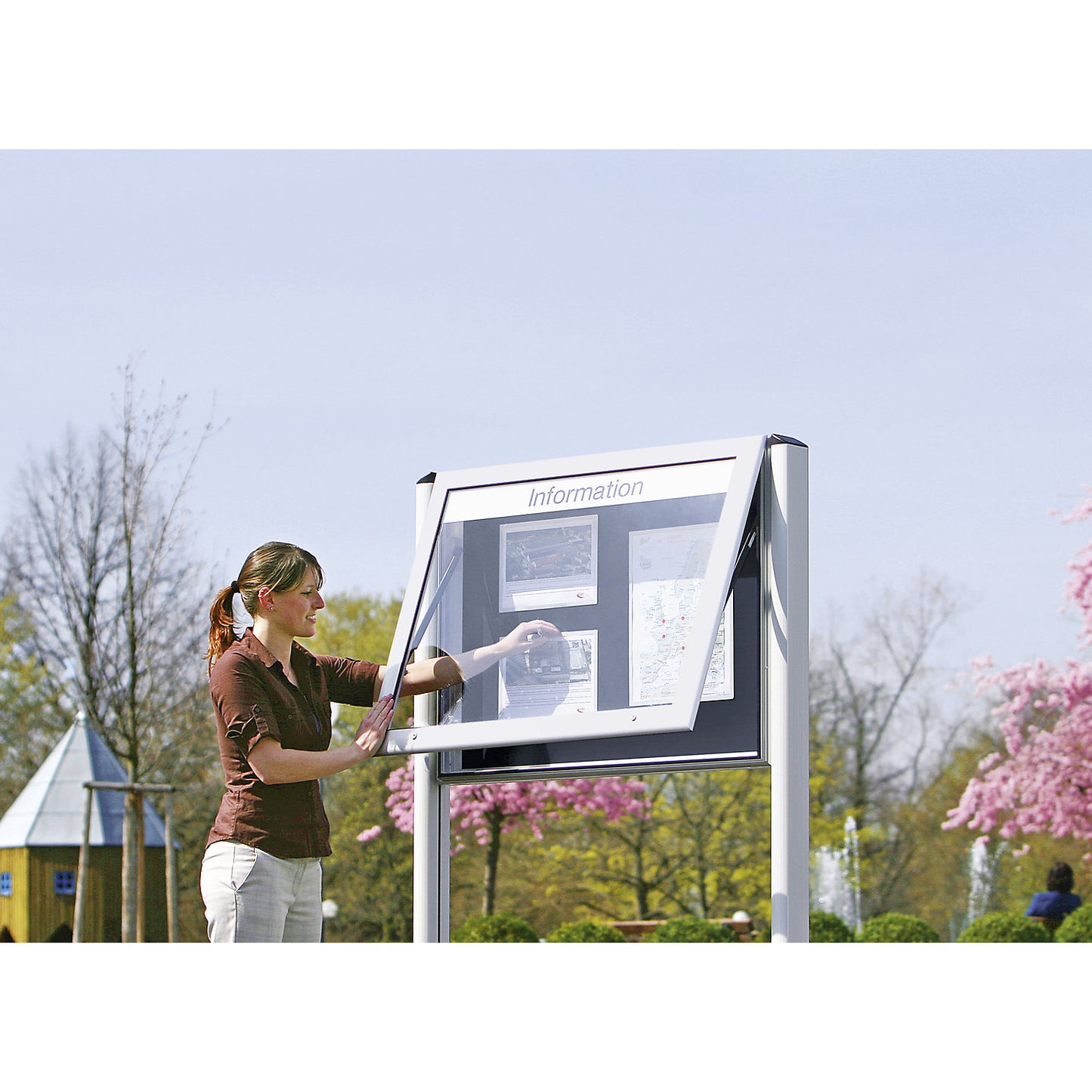 Display case for indoor and outdoor use, landscape format, for A1, door opens upwards 90°, rear panel colour pure white.