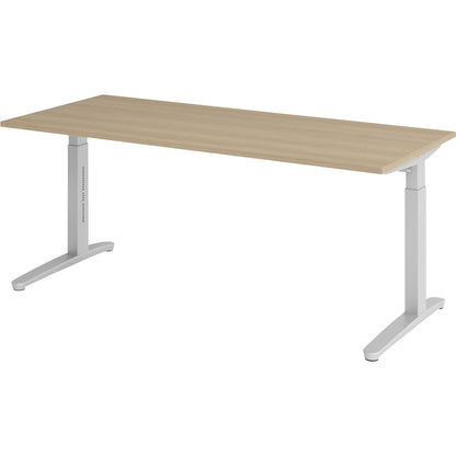 ANNY - Desk with C-foot frame, height adjustable 650 - 850 mm, width 1800 mm, oak / aluminium silver.
